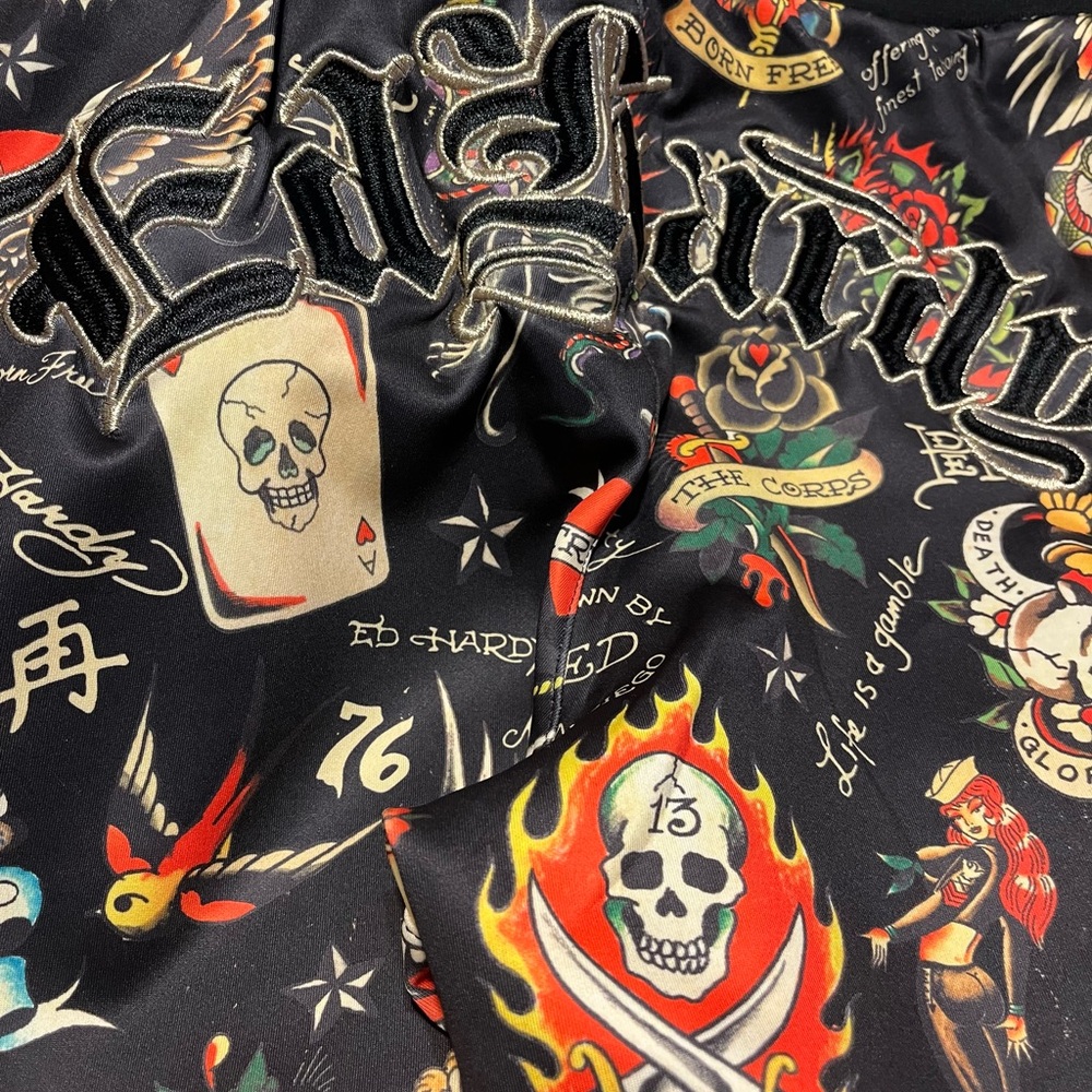 Ed Hardy flashboard pants with Black writing and tattoo Designs worn one time.